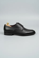 Black leather lace-up dress shoe with classic style and textured finish.